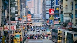 A lively urban scene bustling with people and traffic.