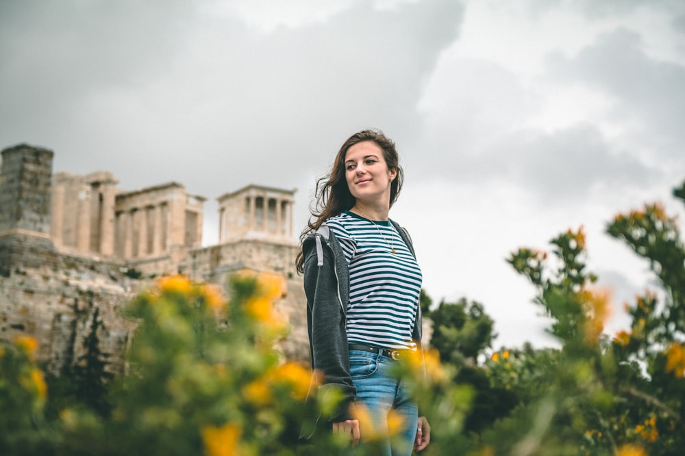 woman wearing striped shirt standing on flower field