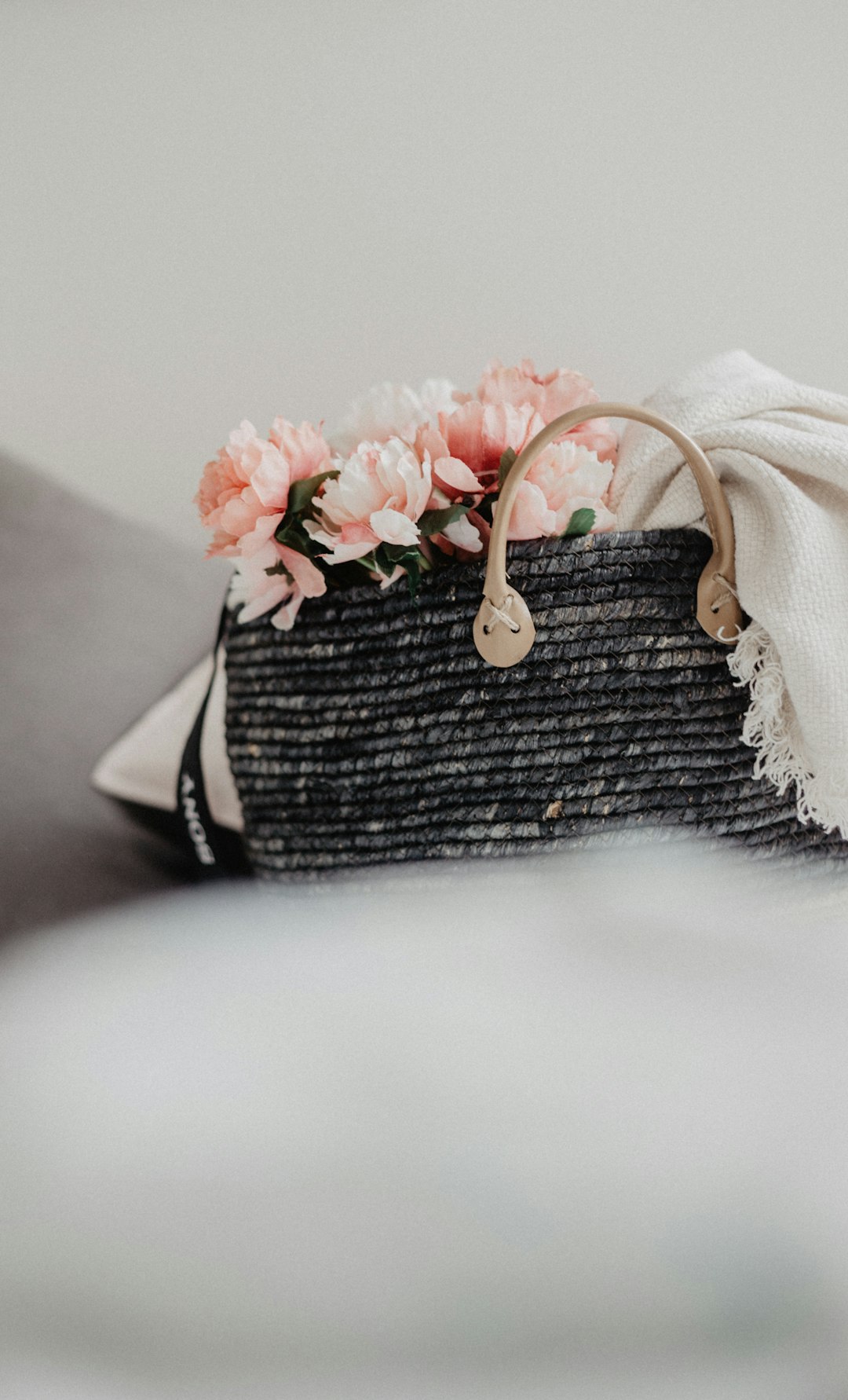 bag of flowers near white wall