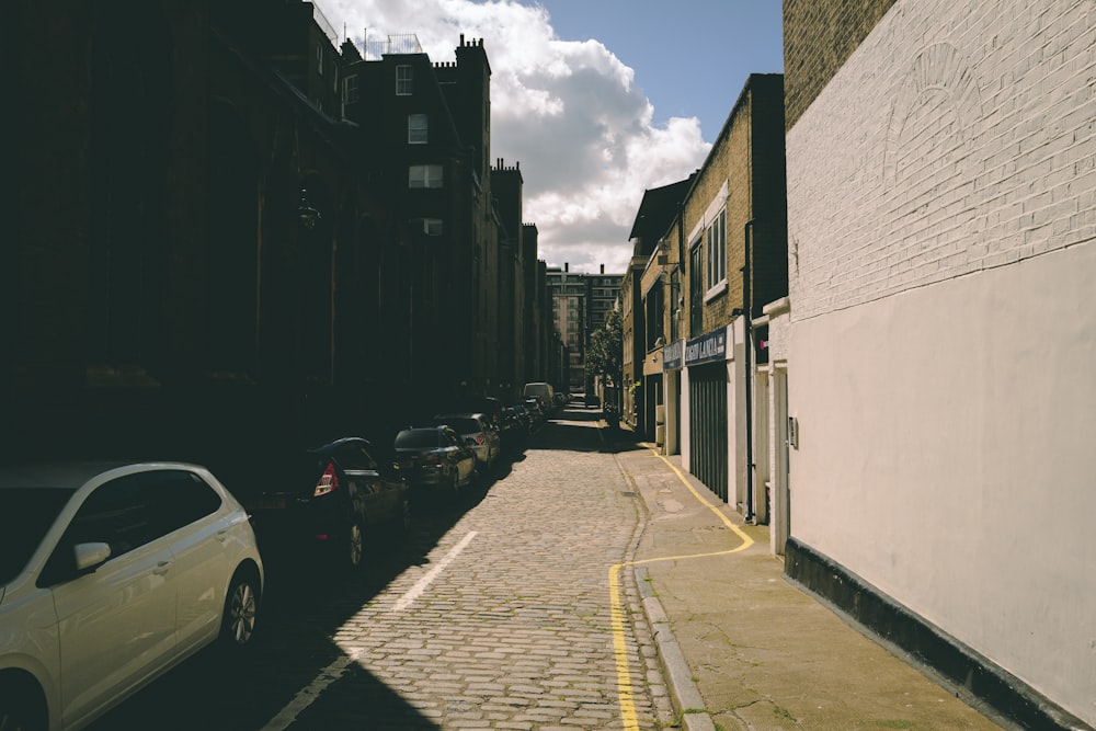 vehicles parked on side of a narrow road