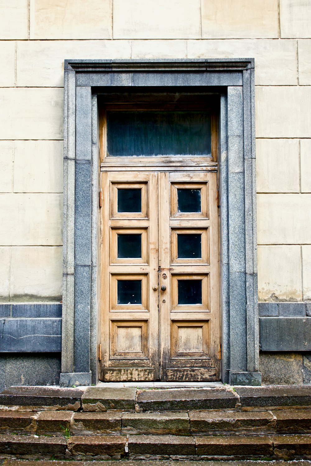 white concrete building showing closed door