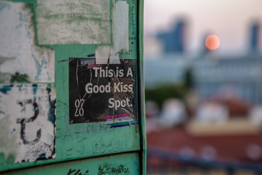 this is a good kiss spot poster on green wall