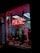 A storefront features a prominently displayed neon sign with the word 'PSYCHIC' in bright red. The window is adorned with red string lights and contains various decorative items, including statues and plants. A poster inside provides additional information on psychic services.