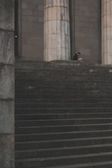 man standing beside pedestal column