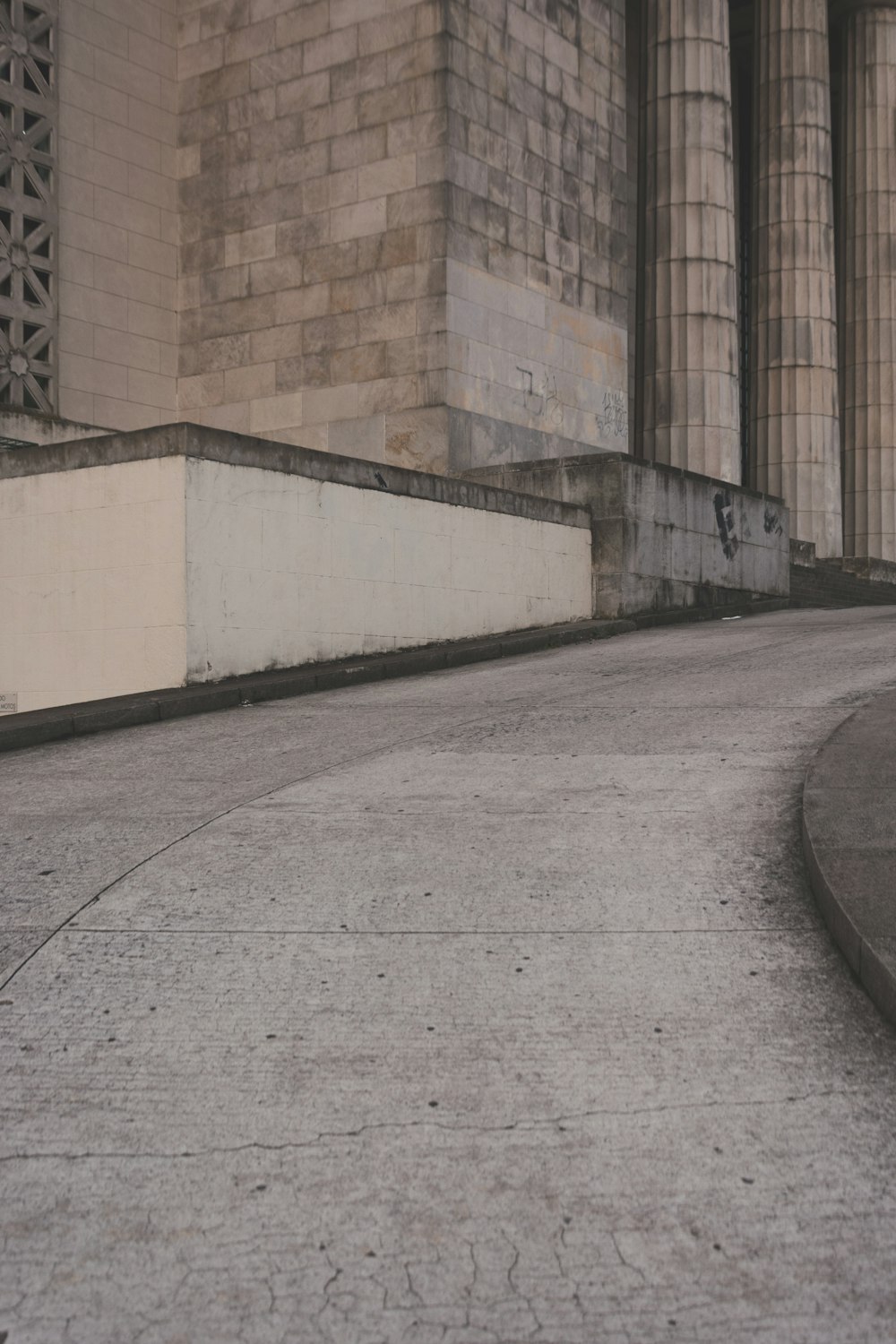 concrete walkway through concrete pillars