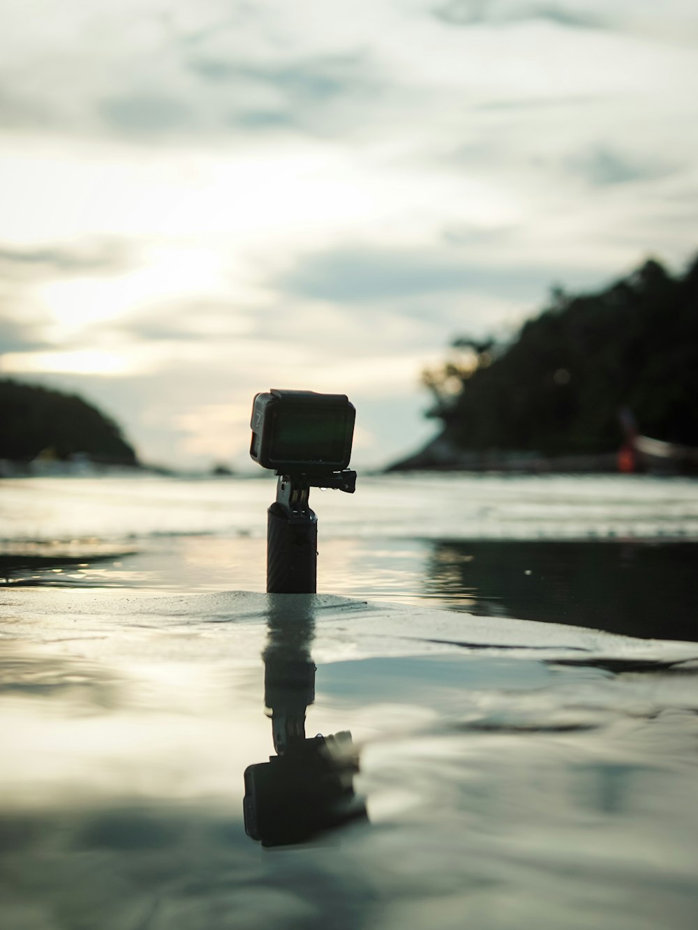 black DSLR camera near body of water