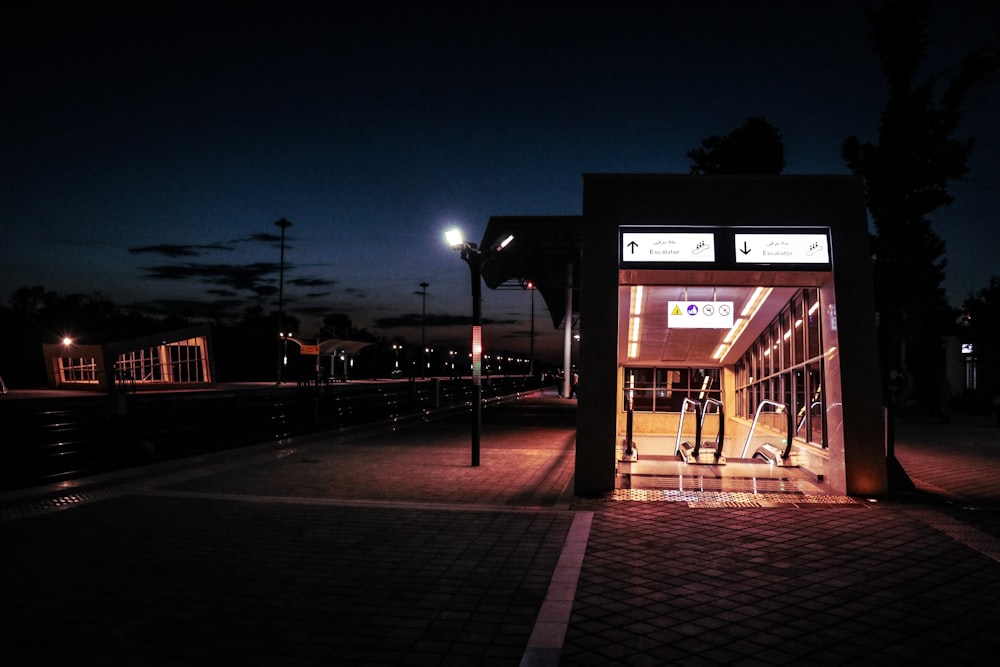 a bus stop at night with the lights on