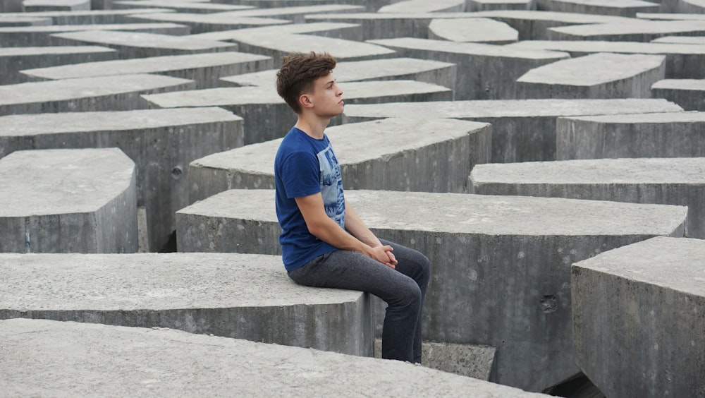 man sitting on rock formations