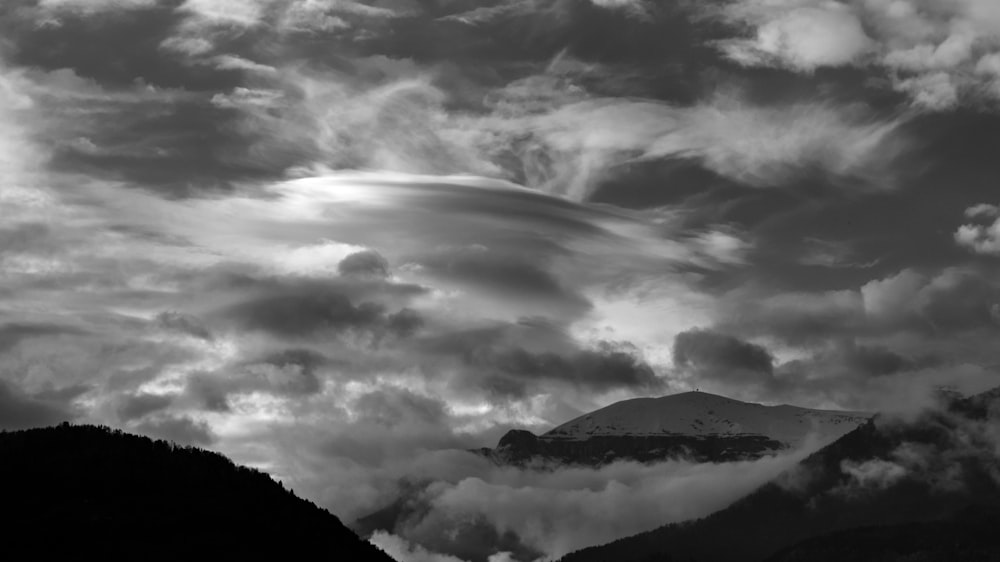 gray-scale photography of mountains with clouds