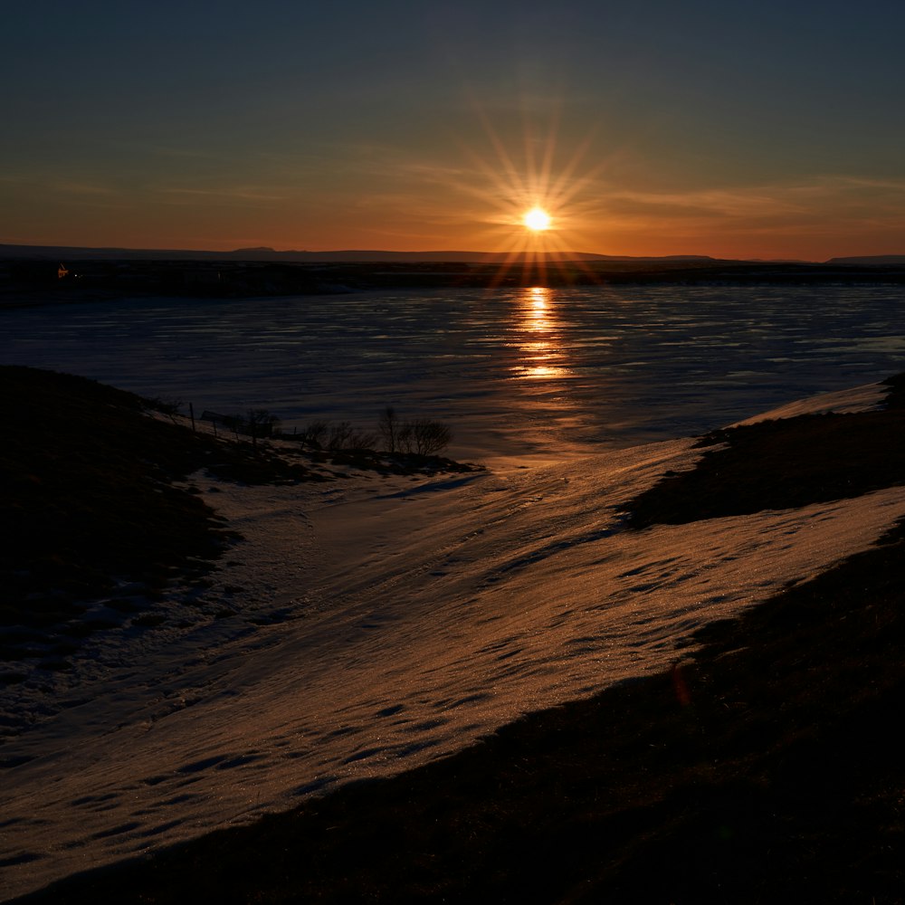 seashore and calm sea during sunset