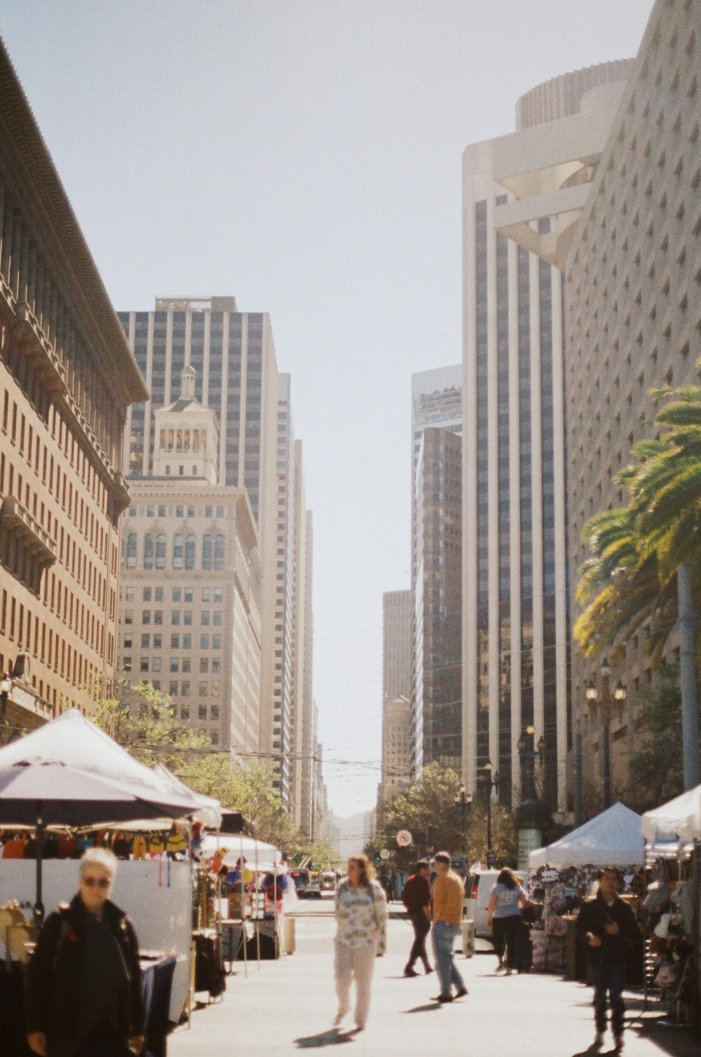 people waking in between high rise buildings