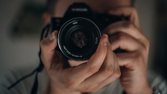 man holding DSLR camera