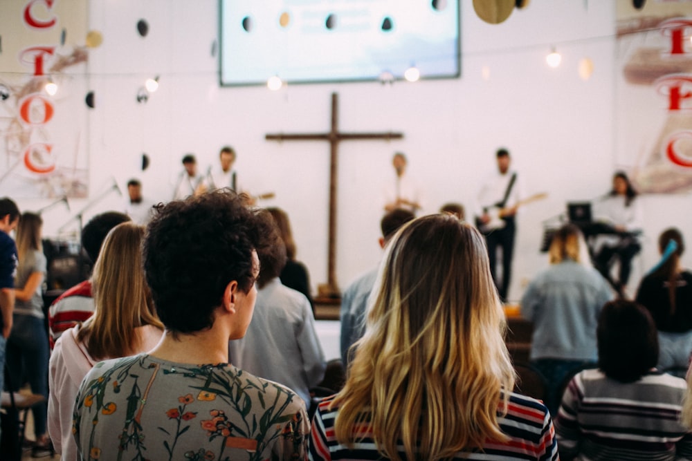 shallow focus photo of people in church