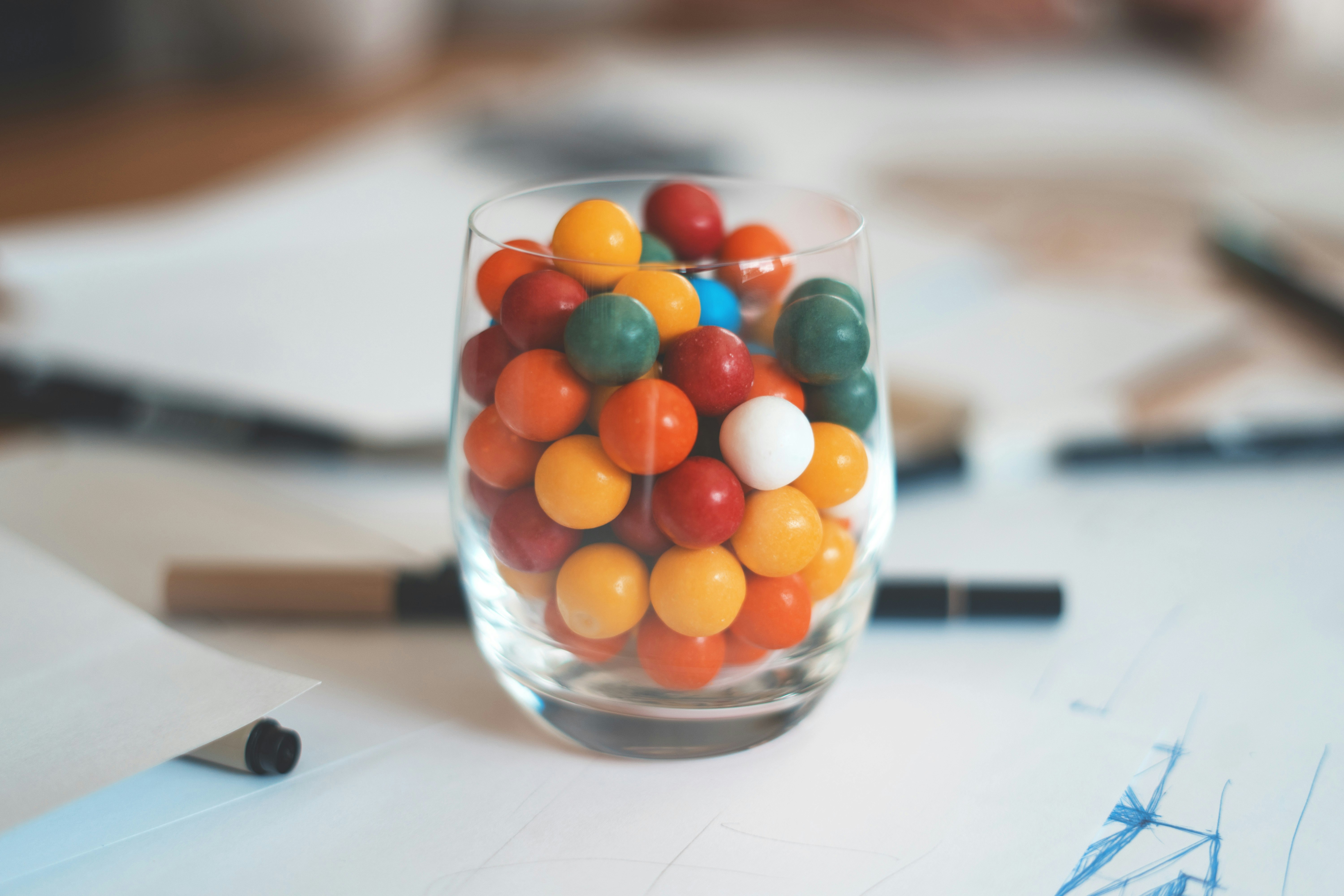 multicolored balls in clear shot glass