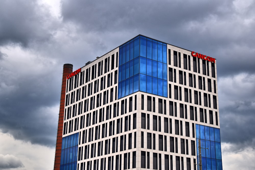 gray and blue concrete building under cloudy sky