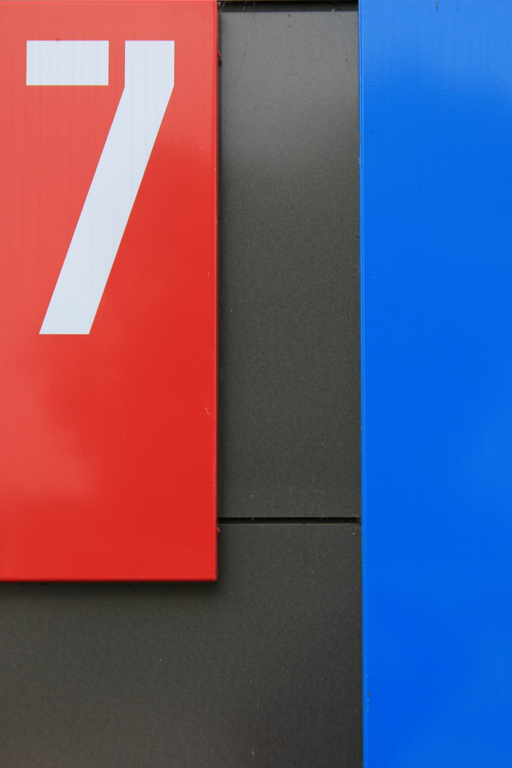a red and blue sign with the number seven on it