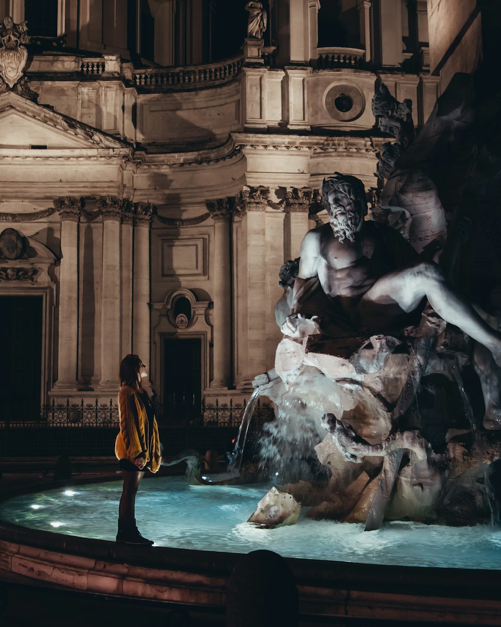 woman standing in front of statue