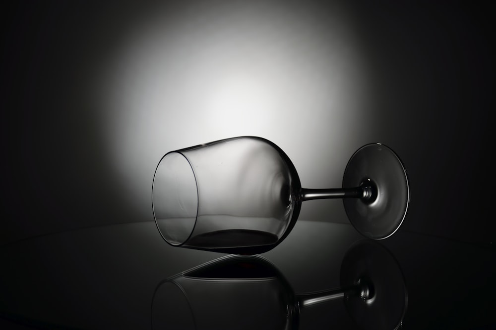 a black and white photo of a wine glass