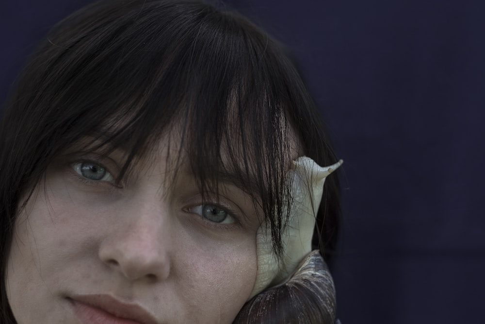 snail crawling on womens face