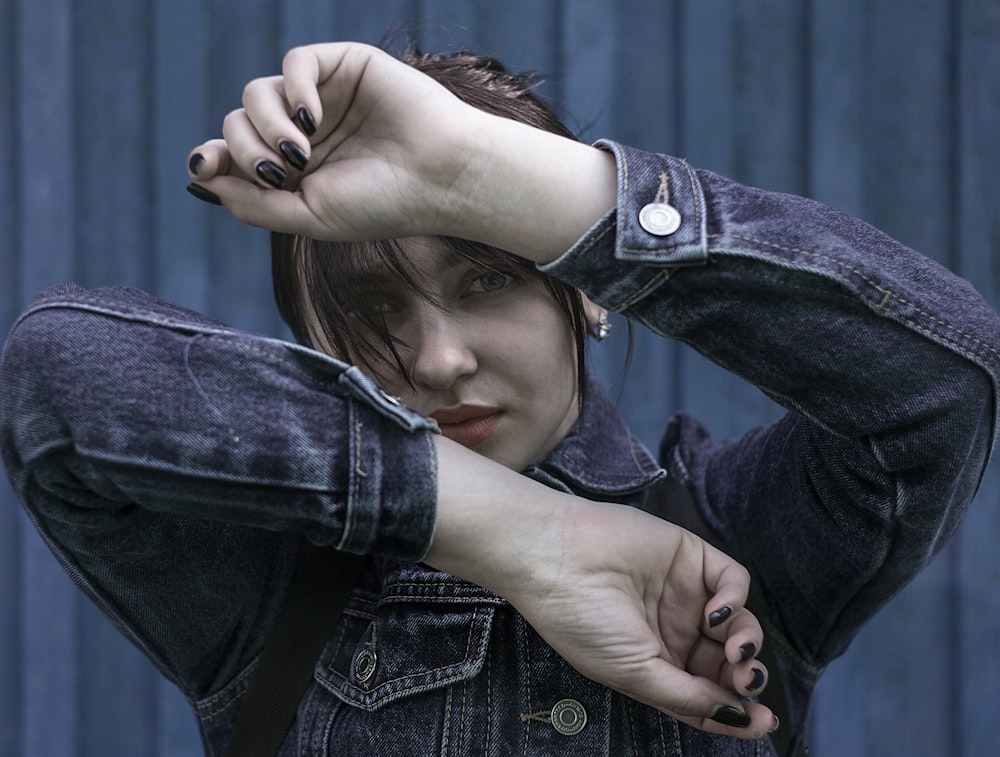 shallow focus photo of woman in blue denim button-up jacket