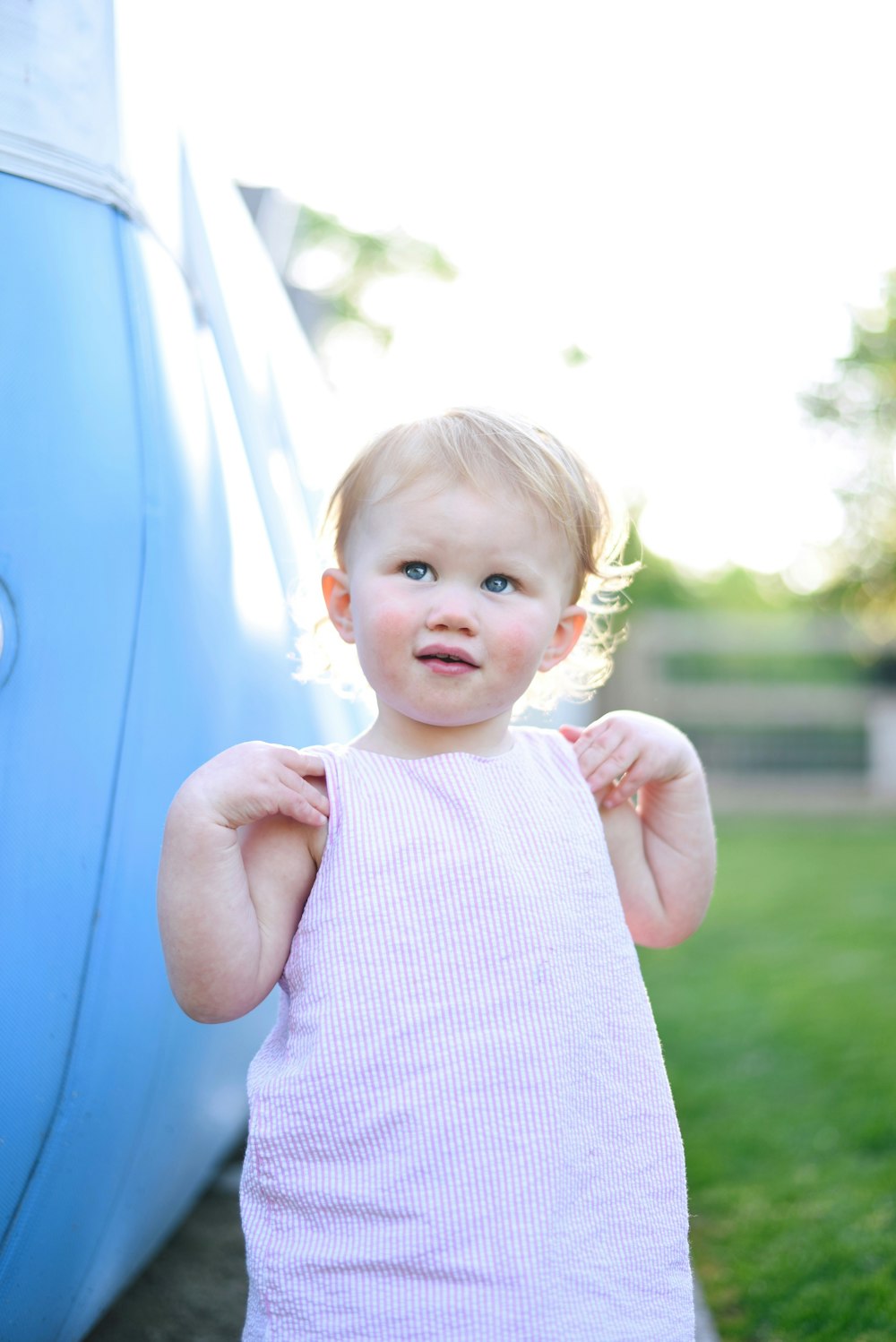 shallow focus photo of toddler in purple sleeveless dress