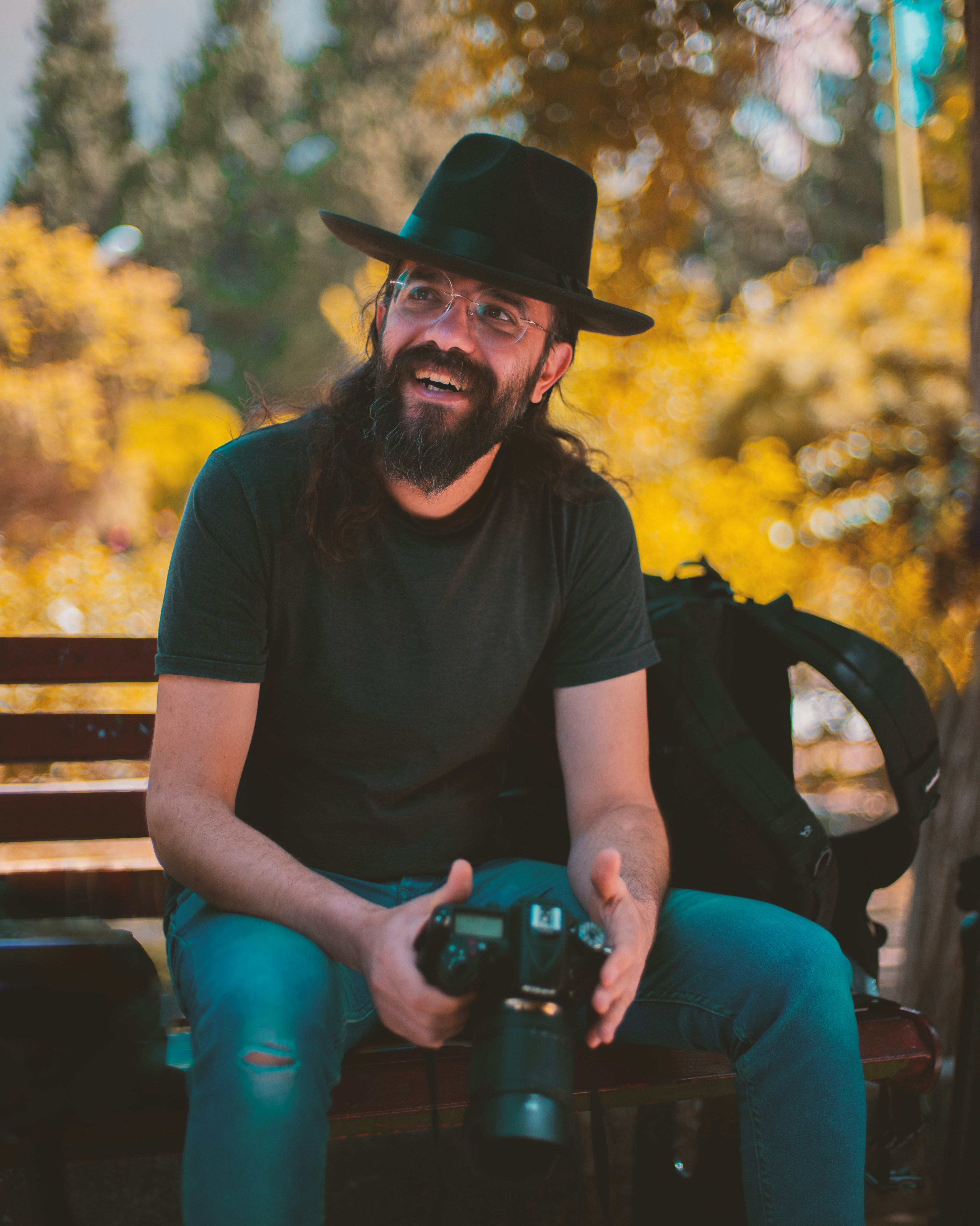 smiling man holding camera