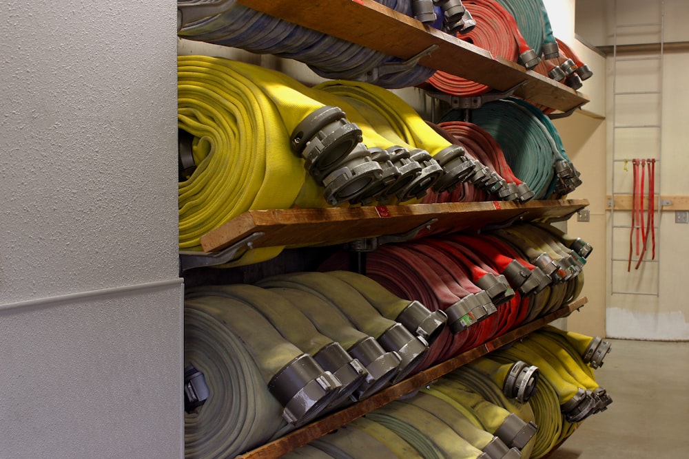 assorted rubber hose lot on rack