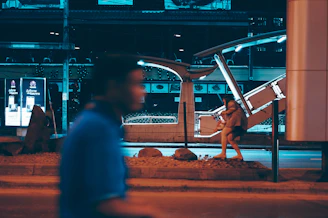 A cinematic video frame showing a musician walking through a city at dusk.