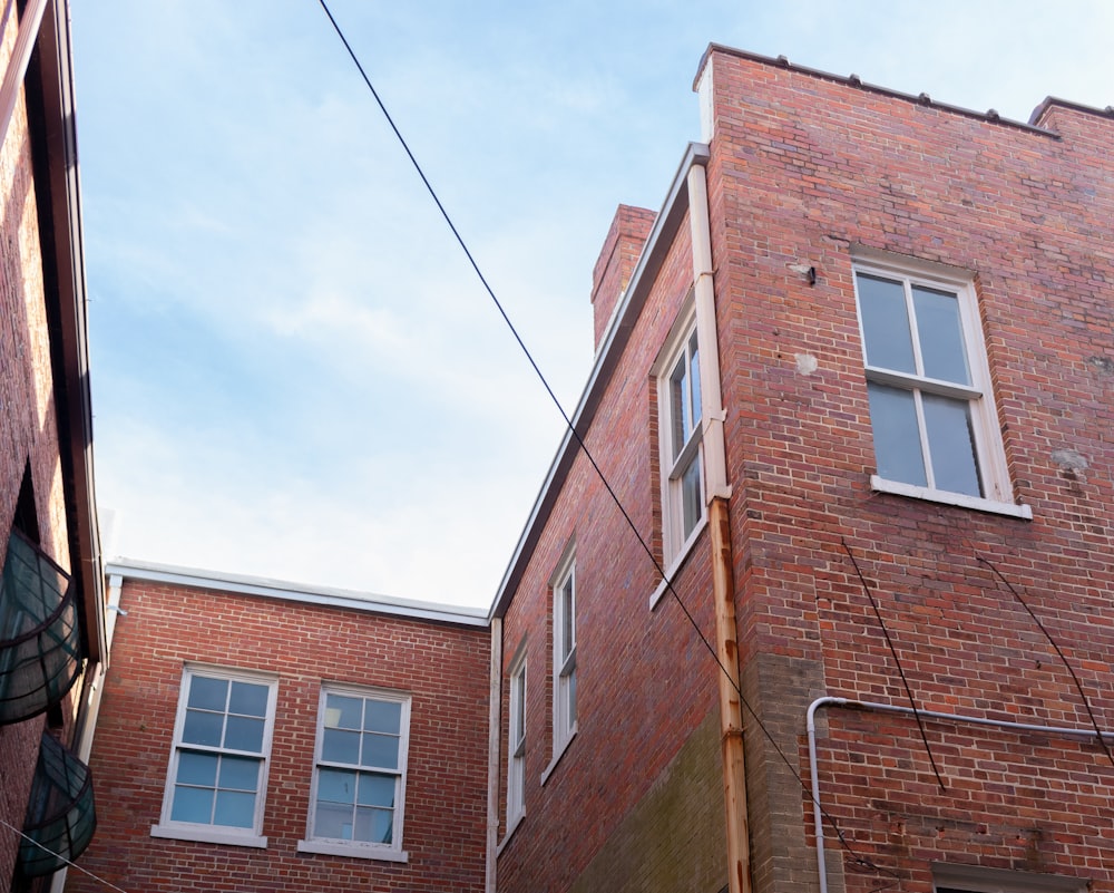 brown concrete building under blue and white skies