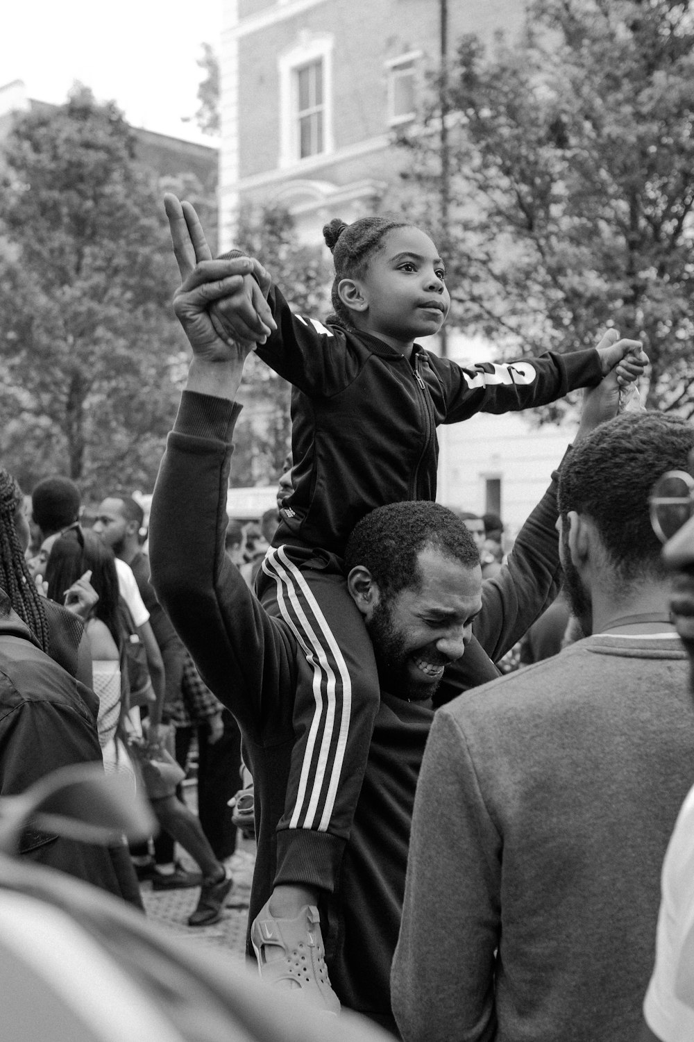 gray scale photo of man carrying girl