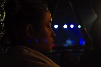 Close-up of Jairaj Kalsy deeply immersed in a live ghazal performance with dim golden stage lights.