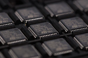 Rows of memory chips neatly arranged on testing racks in a cleanroom.