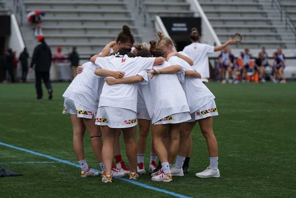 group of woman playing lacrosse sticks