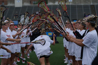 group of person holding lacrosse sticks
