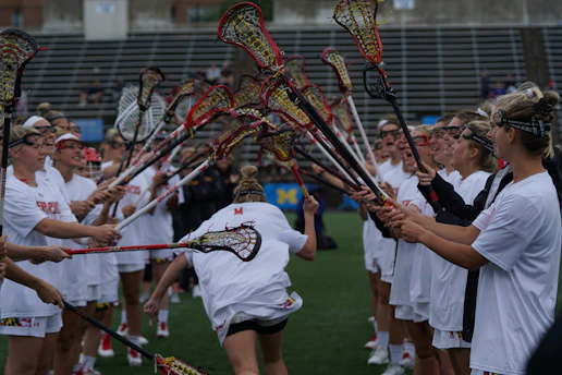 group of person holding lacrosse sticks