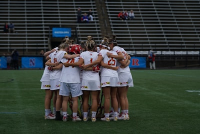 group of person standing on green grass field