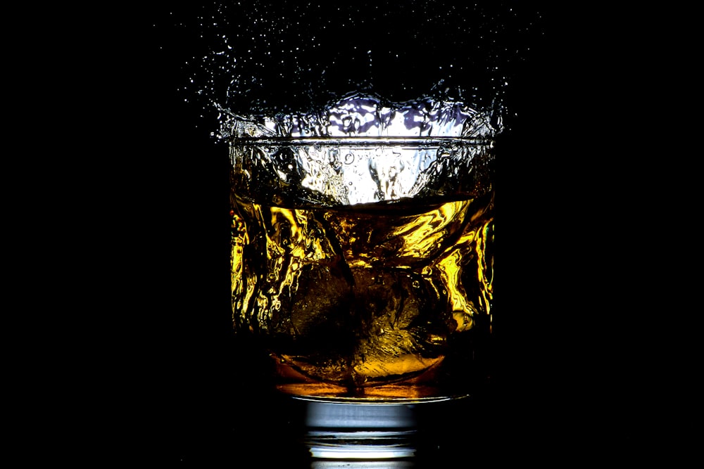 a glass filled with liquid on top of a table