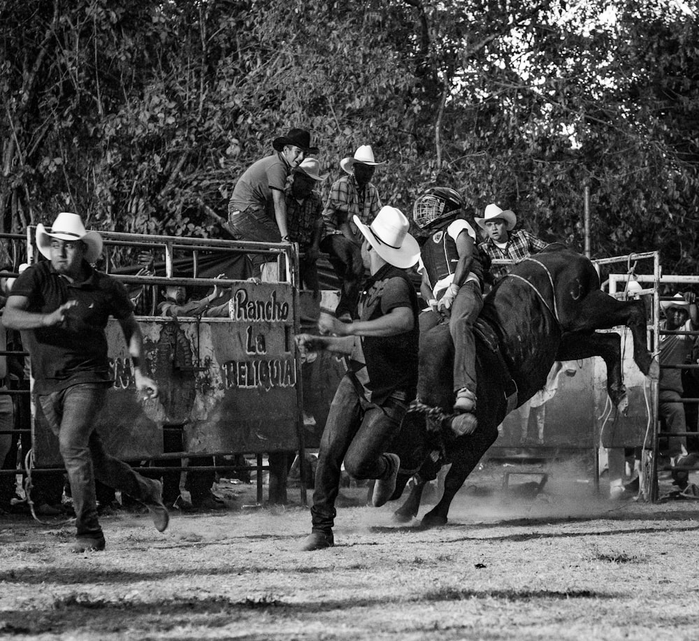 group of men running from bull