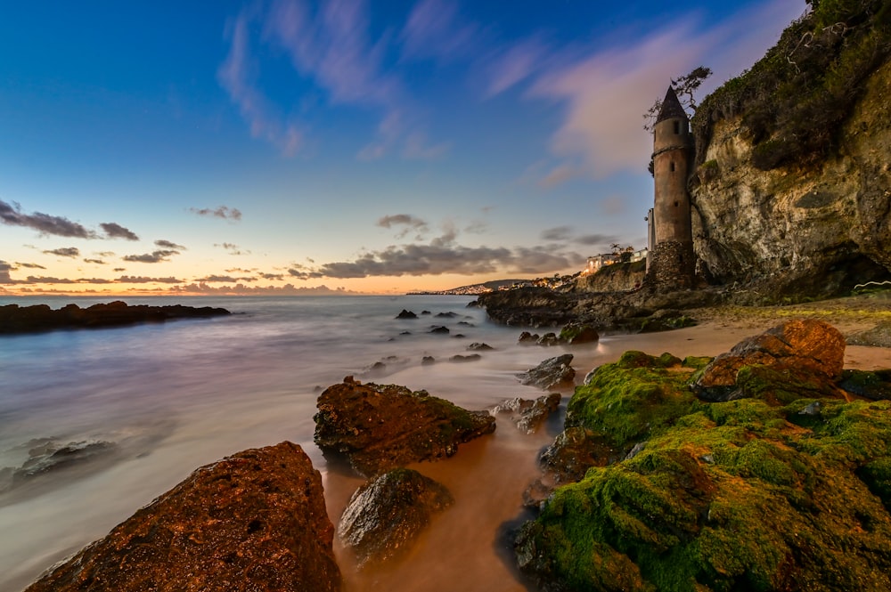 brown seashore rocks during daytime