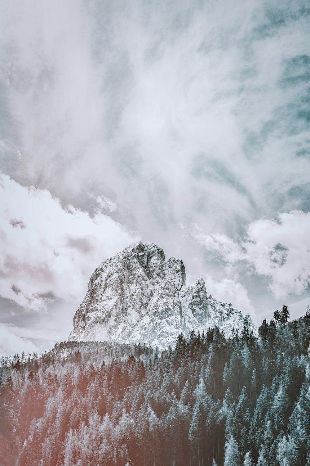 mountain covered with snow under white cloud and blue sky during daytime