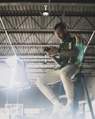 Technician carefully inspecting an Insta360 camera under bright workshop lights.