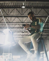 Artisan carefully inspecting a Hahnemühle print under bright studio lights