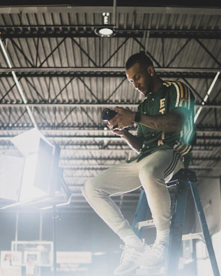 A person changing a light bulb safely with a step ladder.