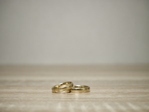 Elegant wedding rings on a minimalist white background.