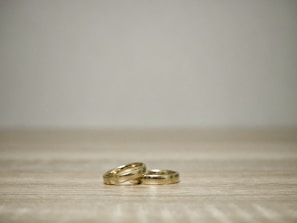 A collection of minimalist rings arranged artistically on a marble surface.
