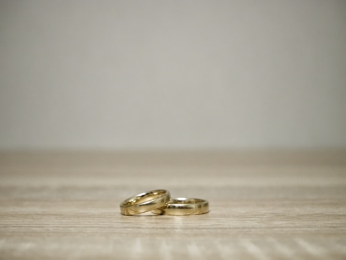 Elegant wedding rings on a minimalist white background.