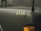A close-up view of a military vehicle with the number 6834 displayed on a matte dark green surface. The image includes an orange indicator light and parts of the vehicle's structure.