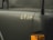 A close-up view of a military vehicle with the number 6834 displayed on a matte dark green surface. The image includes an orange indicator light and parts of the vehicle's structure.