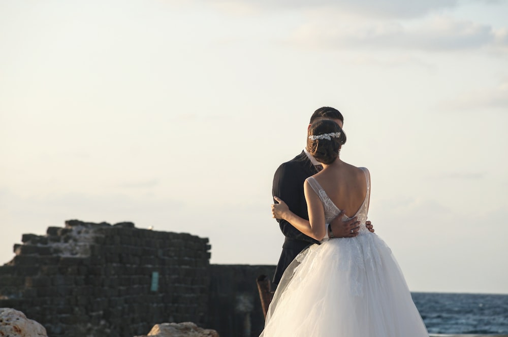 man and woman wearing wedding dress during daytime