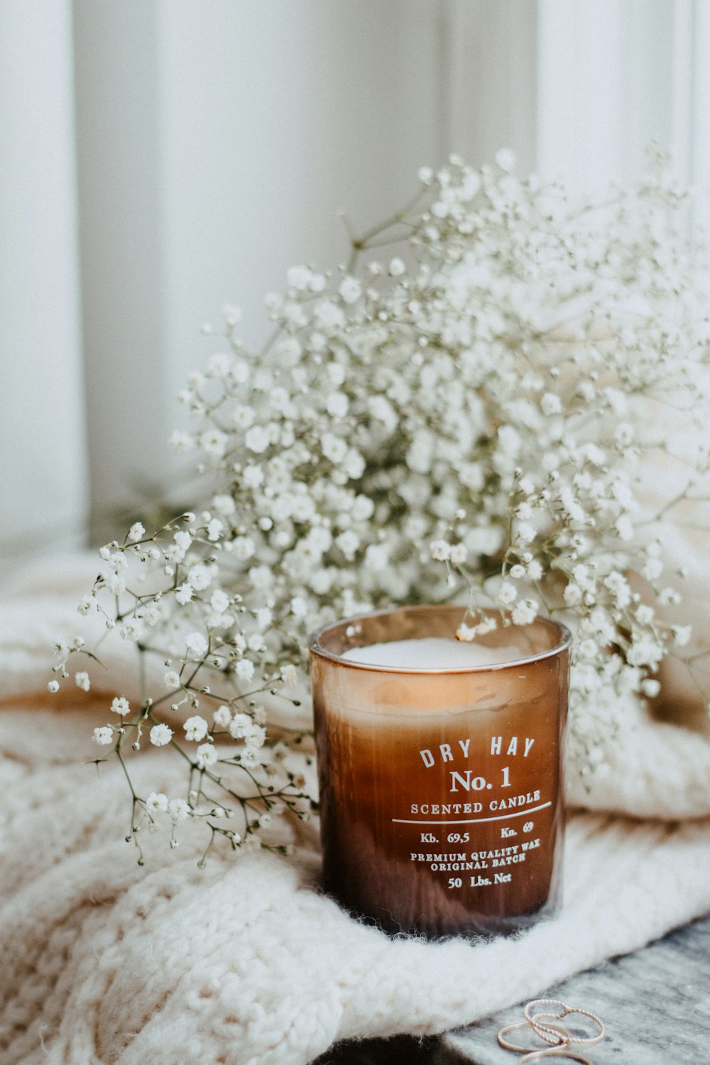 white petaled flower and pillar candle